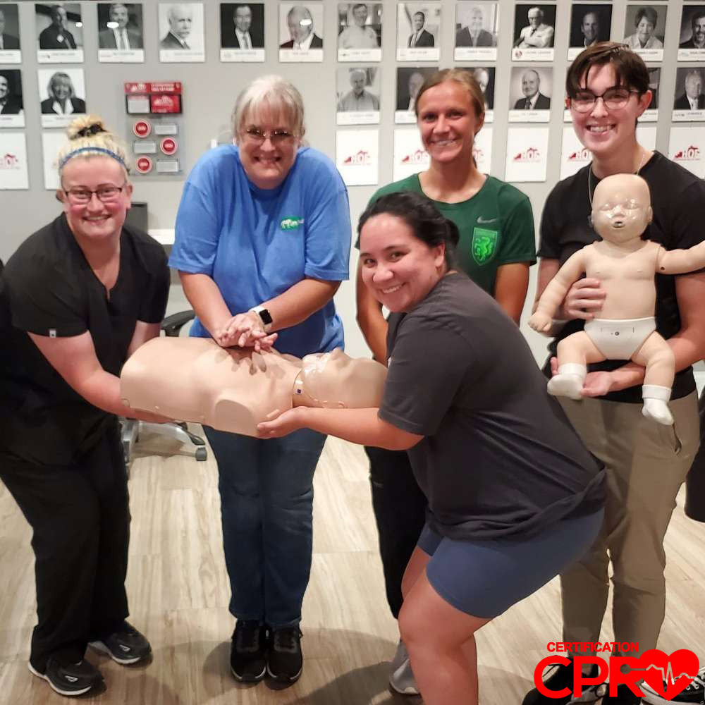 CPR training class in El Paso with students practicing on mannequins.