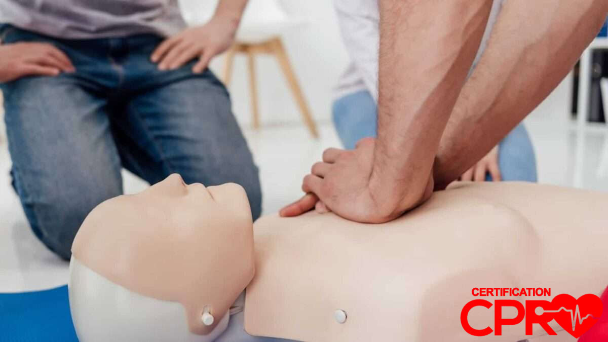 CPR training session with a man practicing on a mannequin in El Paso.